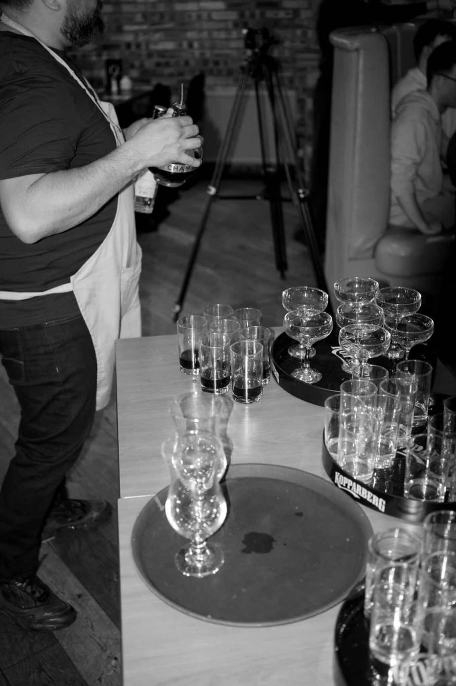 Black and white photo of glasses lined up on trays
