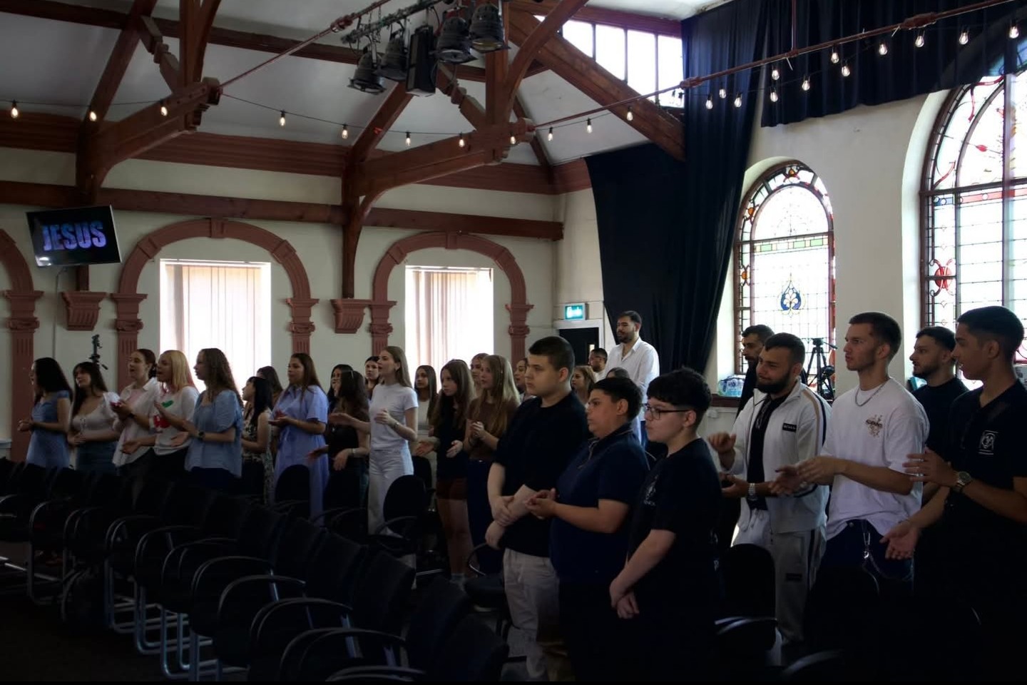 Audience standing in a church hall
