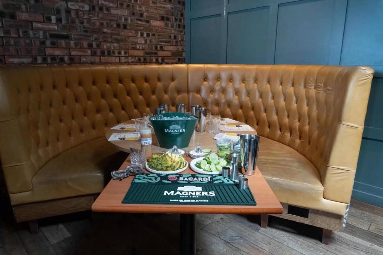 Leather booth set for a cocktail masterclass with Magners and Bacardi bar mats