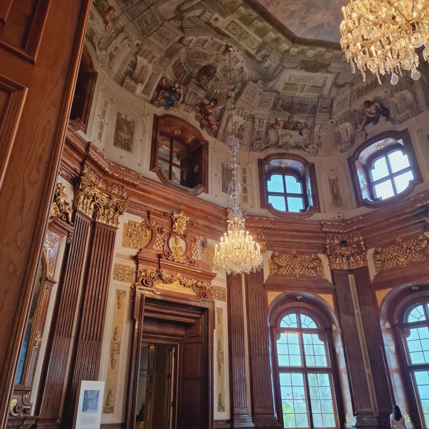 Marble palace hall with chandeliers and painted ceiling