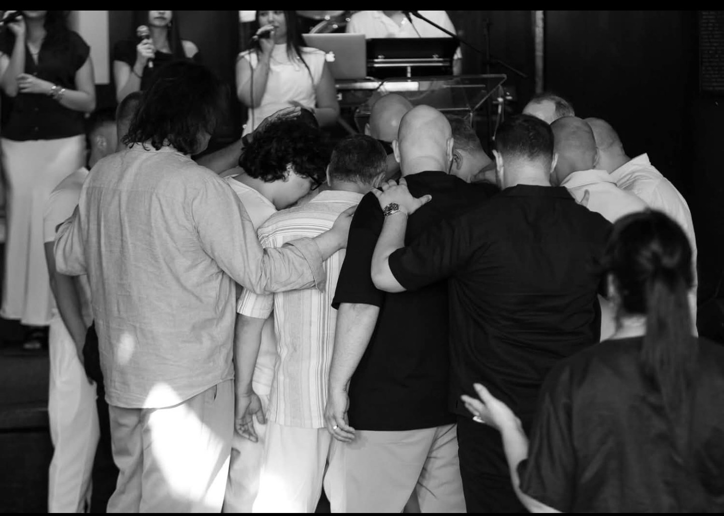 Black and white photo of a group praying together
