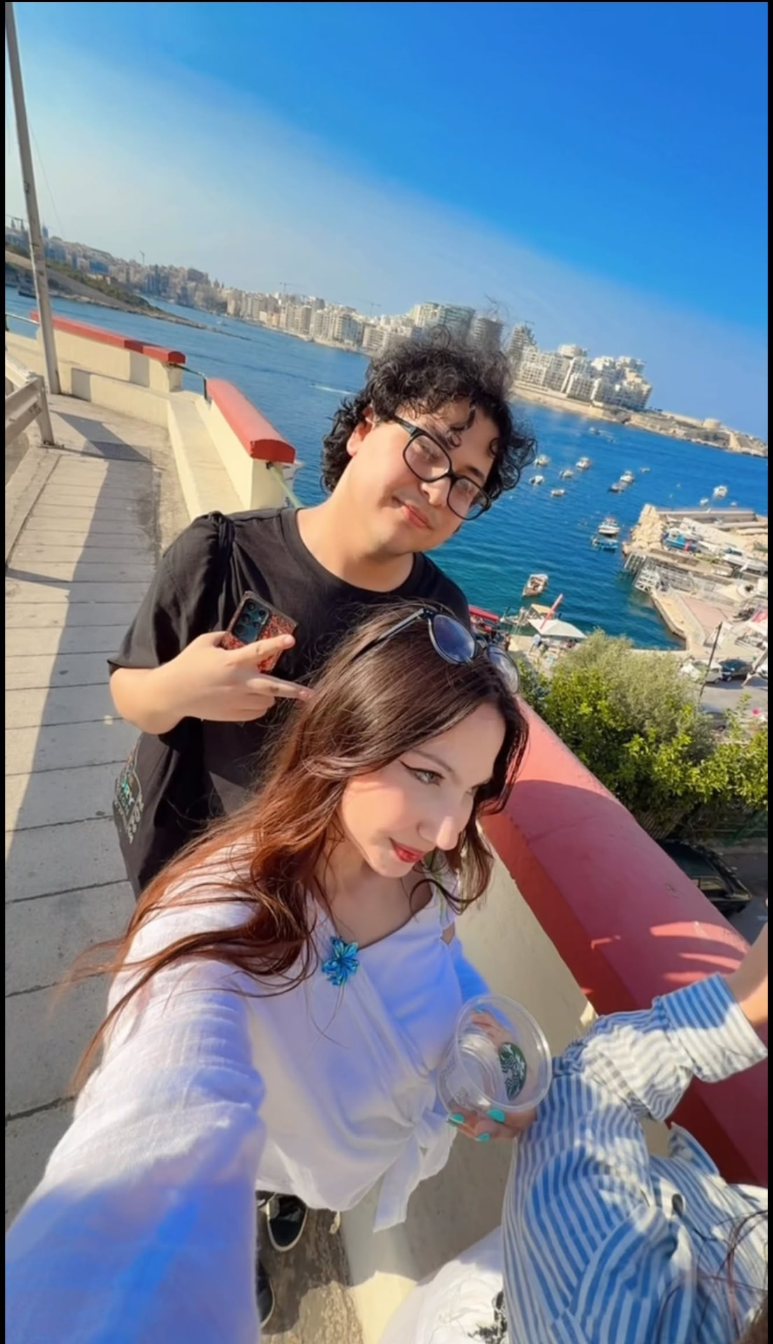 Selfie with a friend on a sunny balcony over the harbour