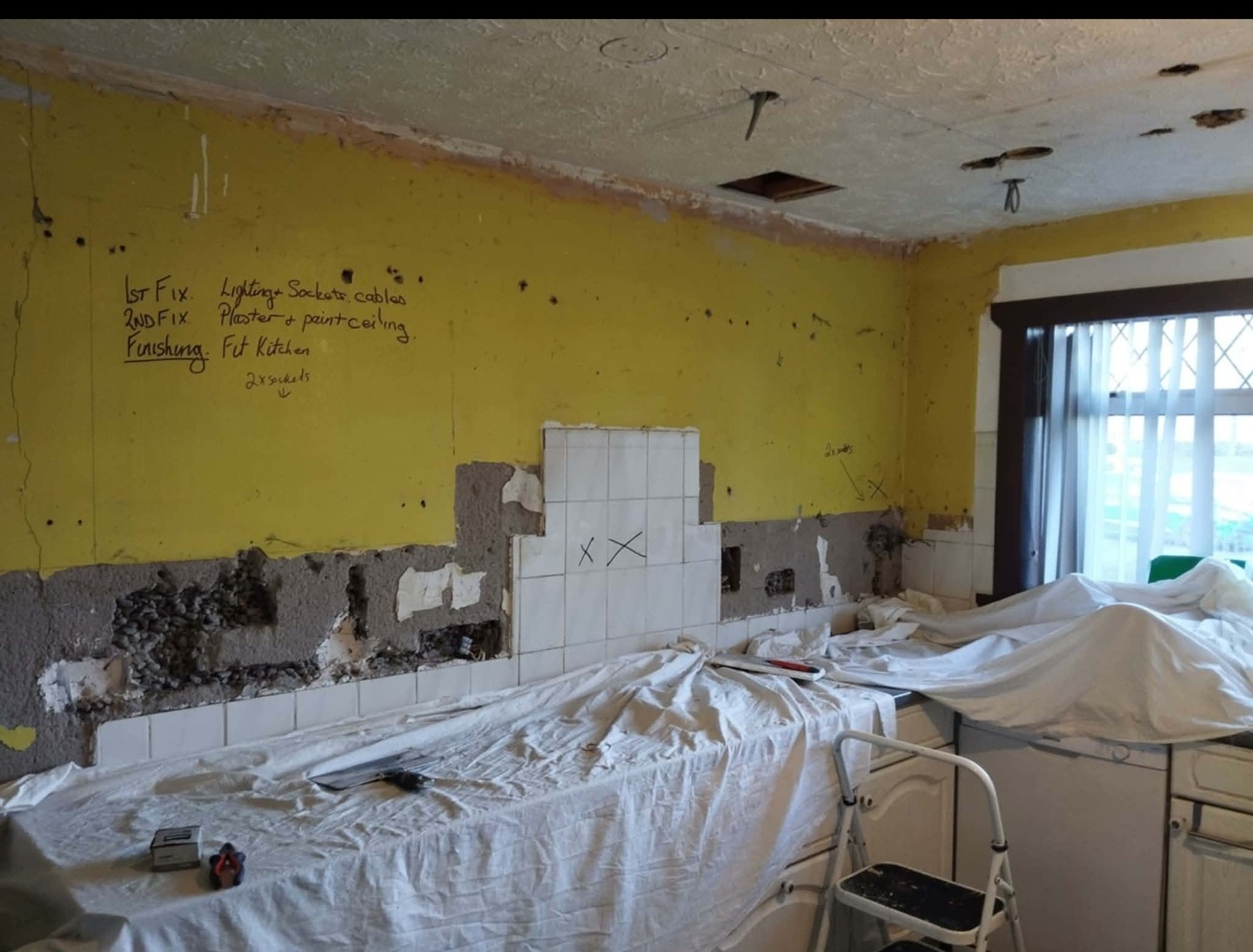 Job D in progress: tiles coming off the kitchen wall