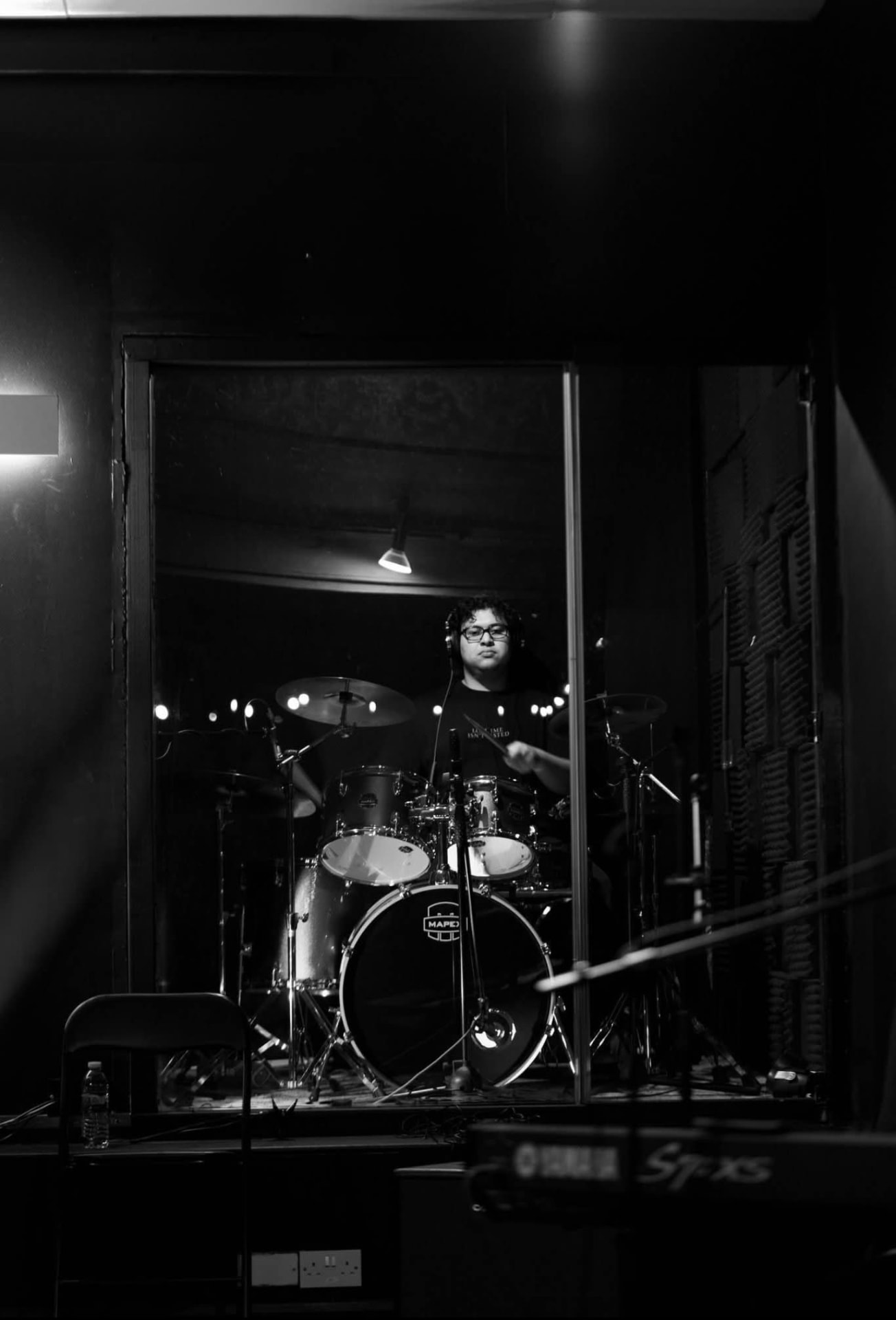 Black and white photo of Samuels playing drums
